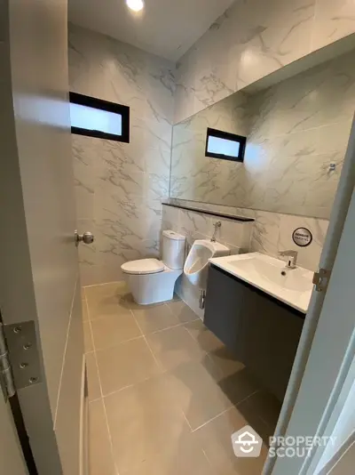 Modern bathroom with marble tiles and sleek fixtures