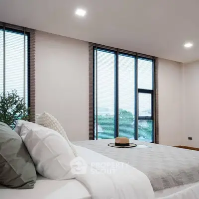 Modern bedroom with large windows and stylish decor