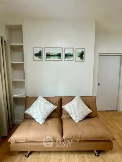 Stylish living room with modern sofa and art decor, perfect for cozy relaxation.