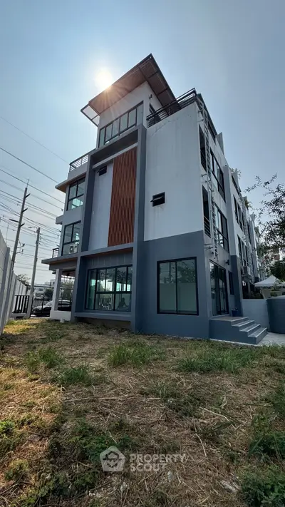 Modern multi-story building with sleek design and large windows, perfect for urban living.