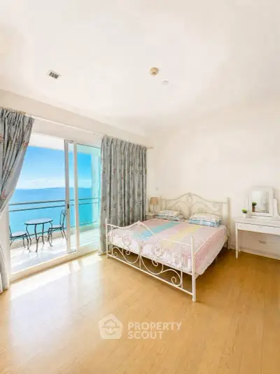 Stunning bedroom with ocean view and balcony access in a luxury apartment.