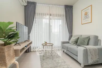 Modern living room with cozy gray sofa and stylish decor