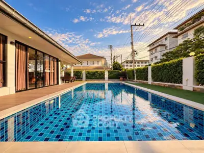 Luxurious residential property with a stunning outdoor pool and modern architecture.
