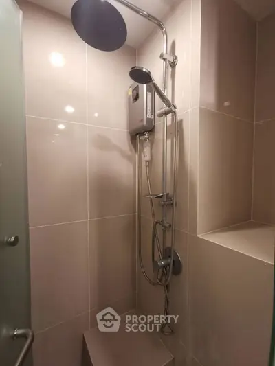 Modern bathroom shower with sleek fixtures and neutral tiles