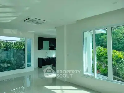 Spacious modern living room with large windows and garden view