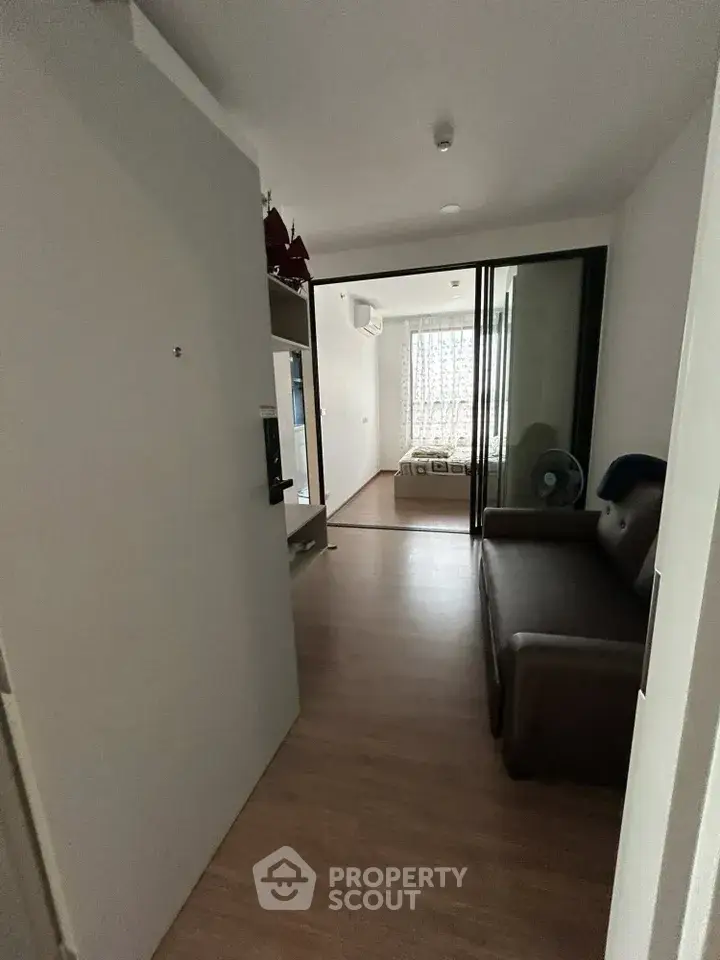 Cozy apartment entrance leading to a compact living area with a view of the bedroom.