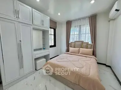 Cozy bedroom with elegant decor and ample natural light