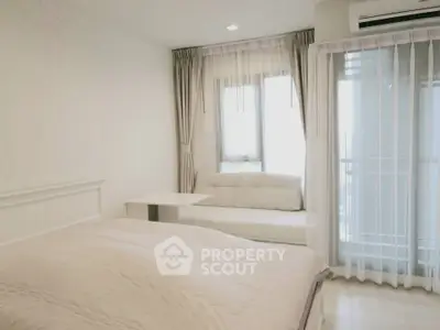 Bright and cozy bedroom with large windows and modern decor, perfect for relaxation.