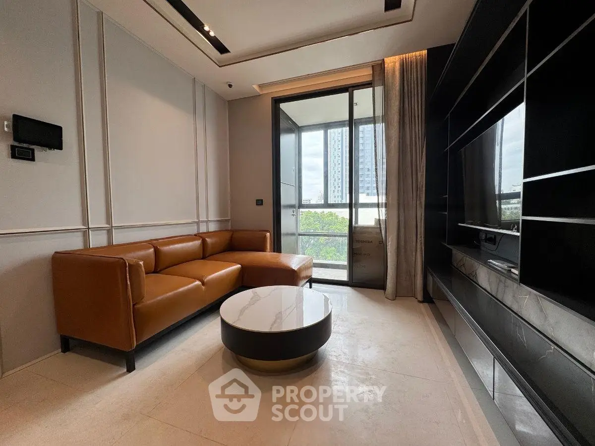 Modern living room with sleek design, leather sofa, and city view balcony in luxury apartment.