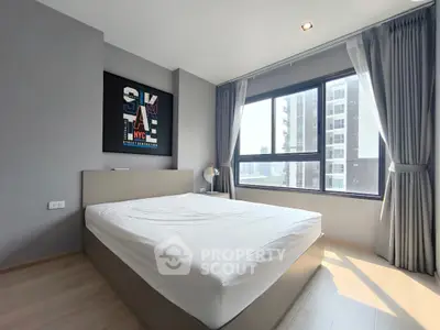 Modern bedroom with large window and stylish decor in urban apartment