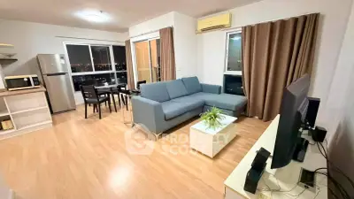 Spacious modern living room with city view, featuring sleek furniture and open layout for comfortable living.