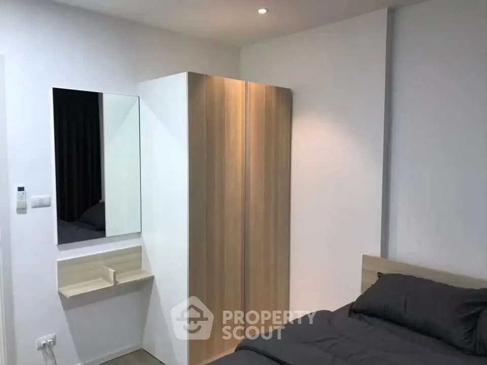 Modern bedroom with sleek wardrobe and cozy bed in minimalist design.