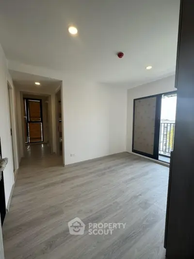 Spacious modern apartment with balcony and sleek flooring