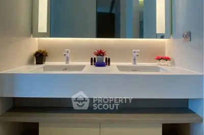 Modern bathroom with dual sinks and ambient lighting