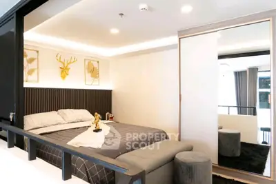 Luxurious modern bedroom with stylish decor and mirrored wardrobe