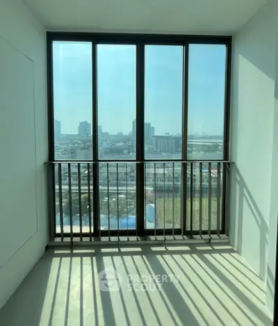 Spacious balcony with panoramic city view and modern railing design.