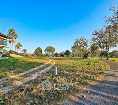 Expansive green land with clear blue sky, perfect for development opportunities.