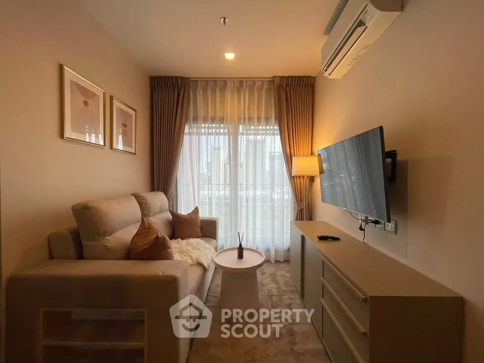 Cozy living room with modern decor, featuring a plush sofa, wall-mounted TV, and elegant curtains.
