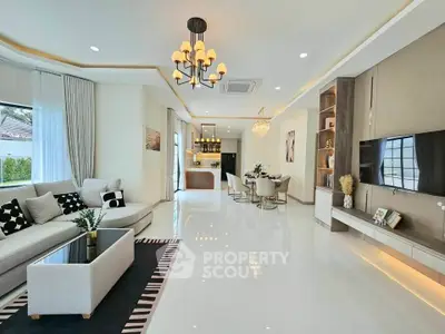 Luxurious open-plan living room with elegant decor and modern lighting