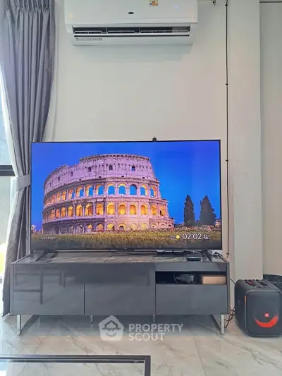 Modern living room with sleek TV setup and air conditioning