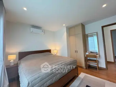 Spacious bedroom with modern furnishings and ample natural light