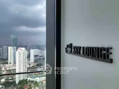 Stunning cityscape view from a high-rise sky lounge with modern decor.