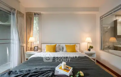 Cozy bedroom with modern decor and large window for natural light