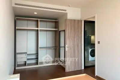 Spacious bedroom with built-in wardrobe and modern laundry area