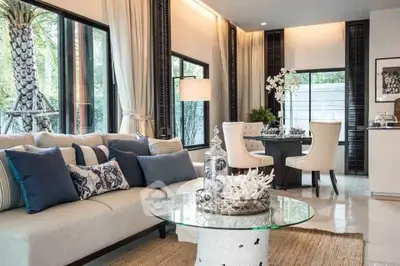 Luxurious living room with elegant decor and large windows offering natural light.