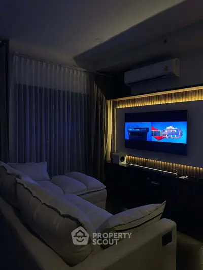 Cozy living room with modern entertainment setup and ambient lighting.