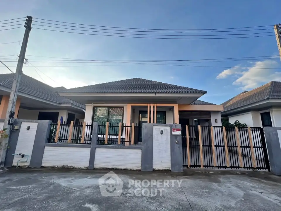 Charming single-story house with modern design and gated entrance in a serene neighborhood.