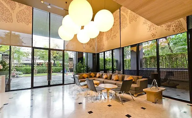 Luxurious modern lobby with elegant seating and large windows overlooking a lush garden.