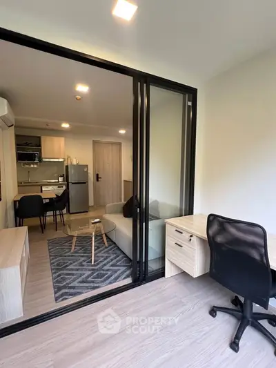 Modern apartment interior with open layout, featuring a cozy living room and stylish kitchen area.