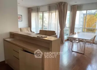 Spacious living room with natural light and modern furniture in a stylish apartment.