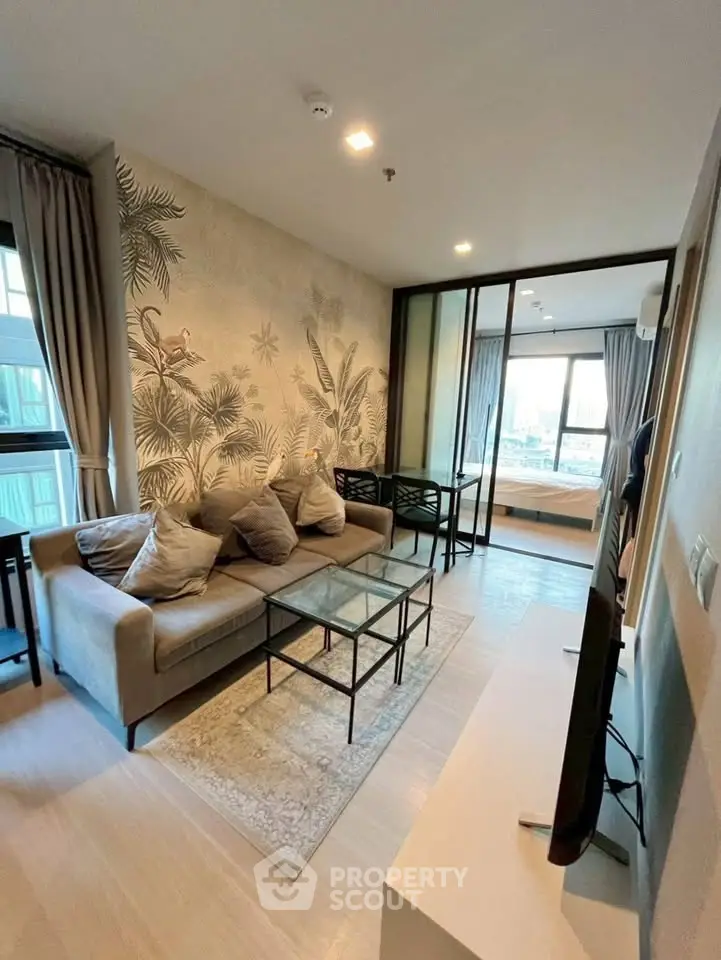 Stylish living room with modern decor and large windows in a contemporary apartment.