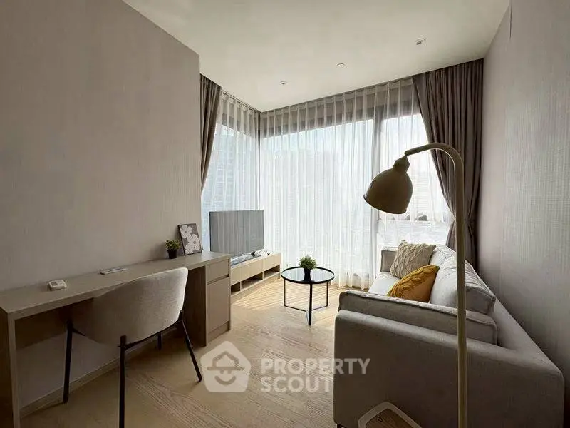 Modern living room with natural light, cozy sofa, and stylish decor