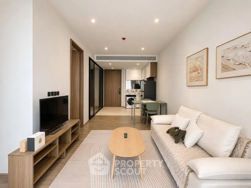 Modern living room with stylish decor and open kitchen layout in a contemporary apartment.
