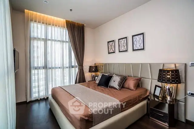 Luxurious modern bedroom with elegant decor and large window for natural light.