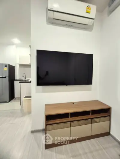 Modern living room with wall-mounted TV and sleek air conditioning unit.