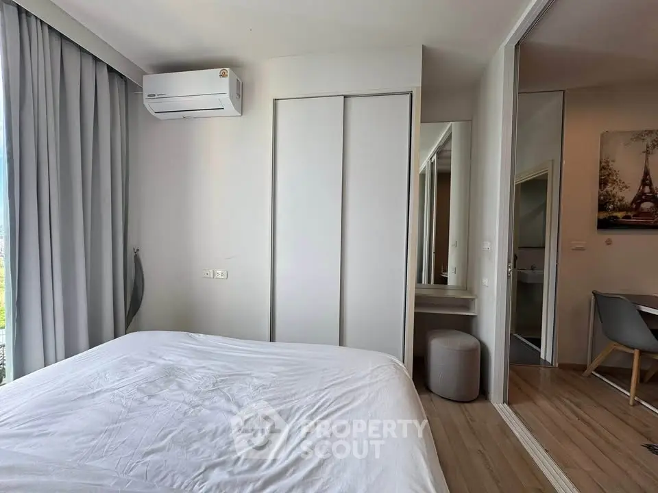 Modern bedroom with sleek design, featuring a comfortable bed, air conditioning, and ample storage space.
