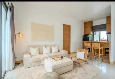 Modern living room with cozy seating and stylish decor in open layout apartment.