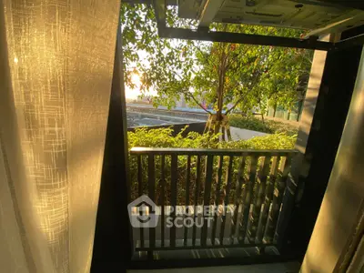 Charming balcony view with lush greenery and warm sunlight