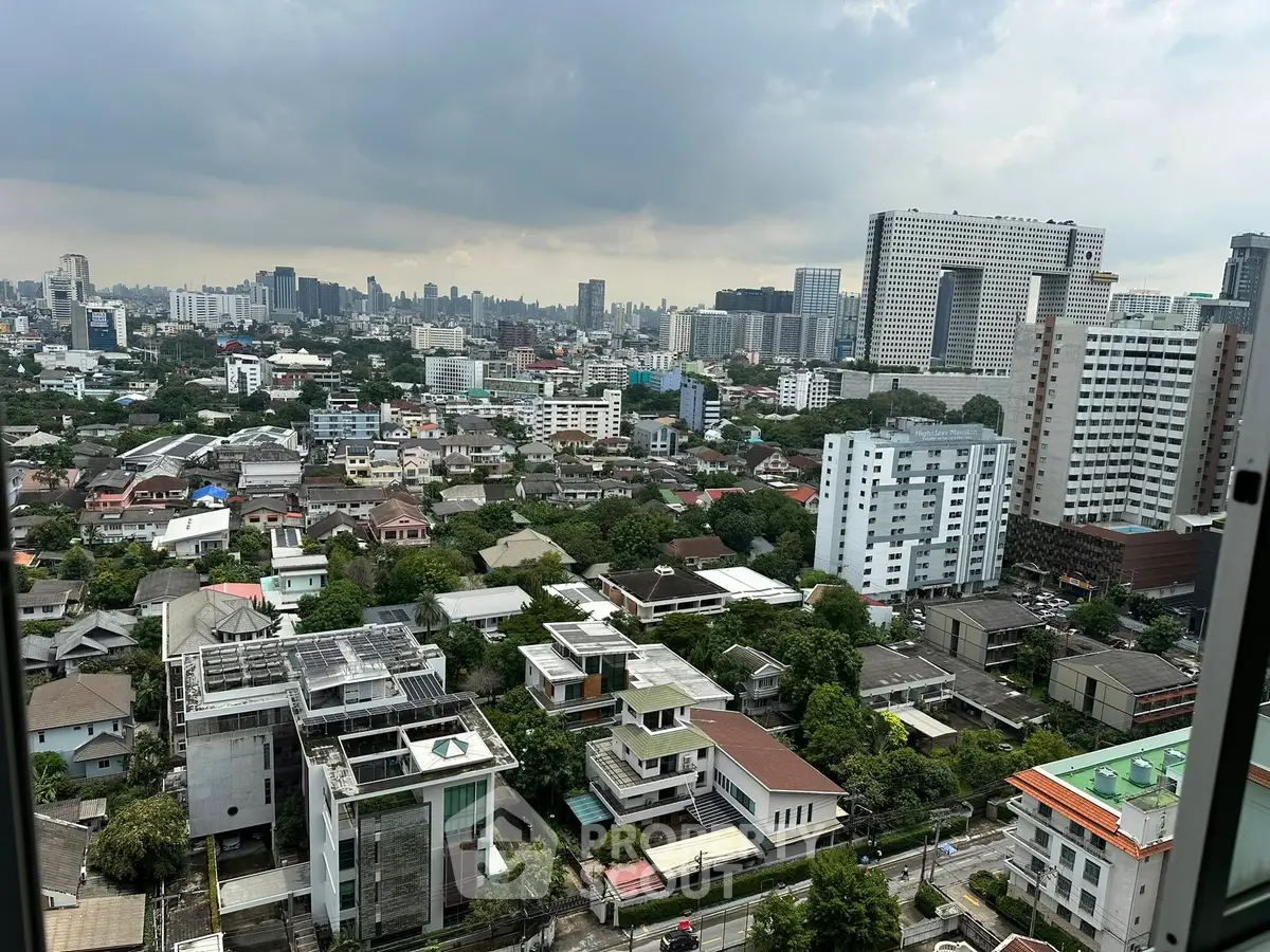 Stunning cityscape view from high-rise building showcasing urban skyline and residential areas.