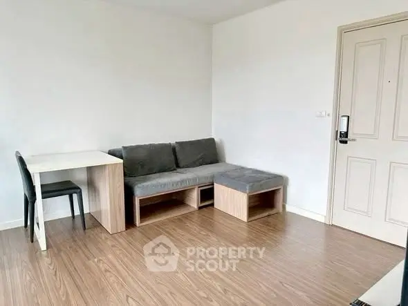 Modern living room with wooden flooring and minimalist furniture