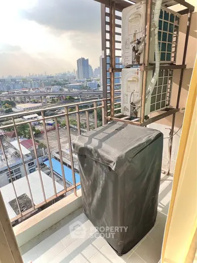High-rise balcony with city view and air conditioning unit, perfect for urban living.