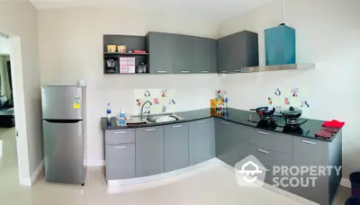 Modern kitchen with sleek gray cabinets and stainless steel appliances