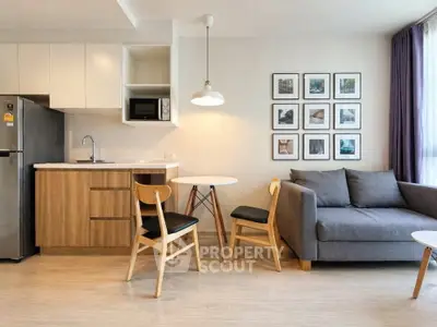Modern living room with stylish furniture and open kitchen layout, perfect for urban living.