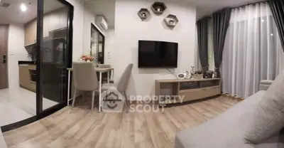 Modern living room with open kitchen, stylish decor, and cozy ambiance