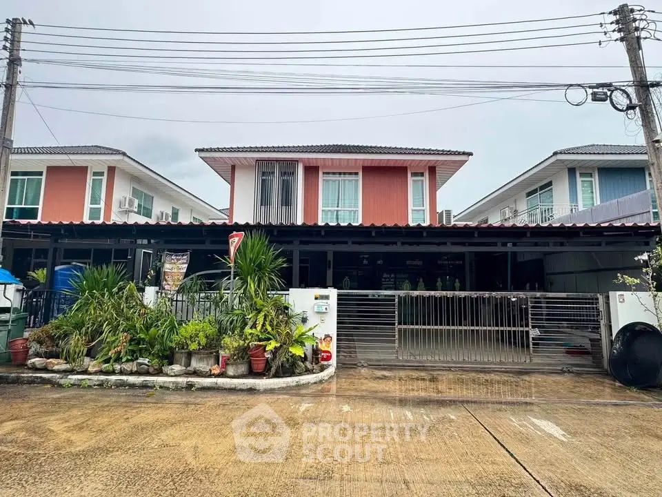 Charming two-story suburban home with modern facade and lush front garden, perfect for family living.