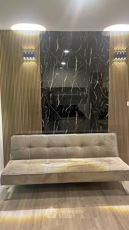 Modern interior with stylish sofa and elegant wall design, perfect for contemporary living spaces.